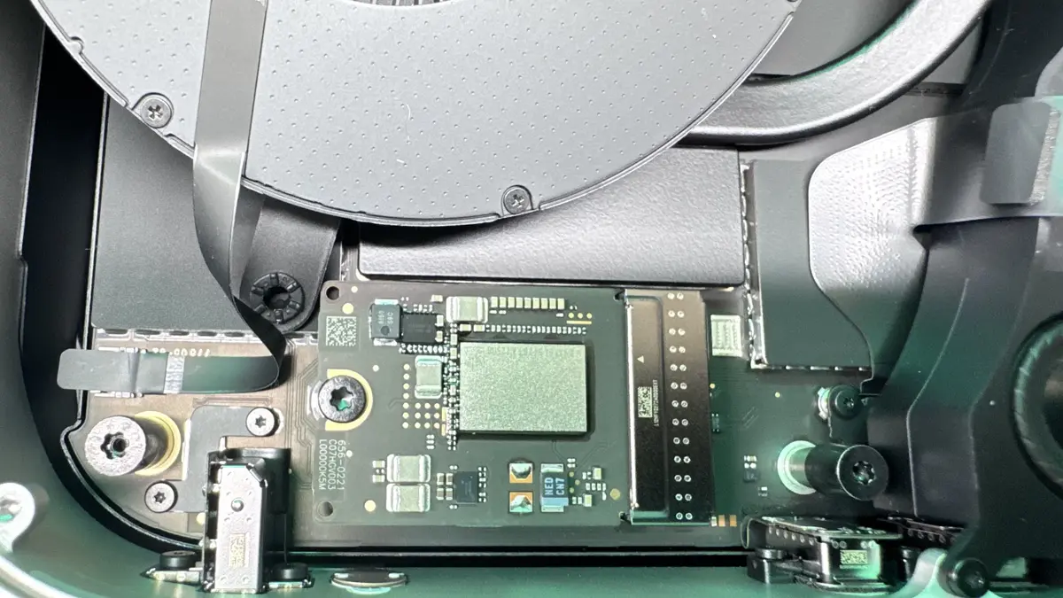 Mac Mini internals showing SSD module and logic board during upgrade at WarriorMac