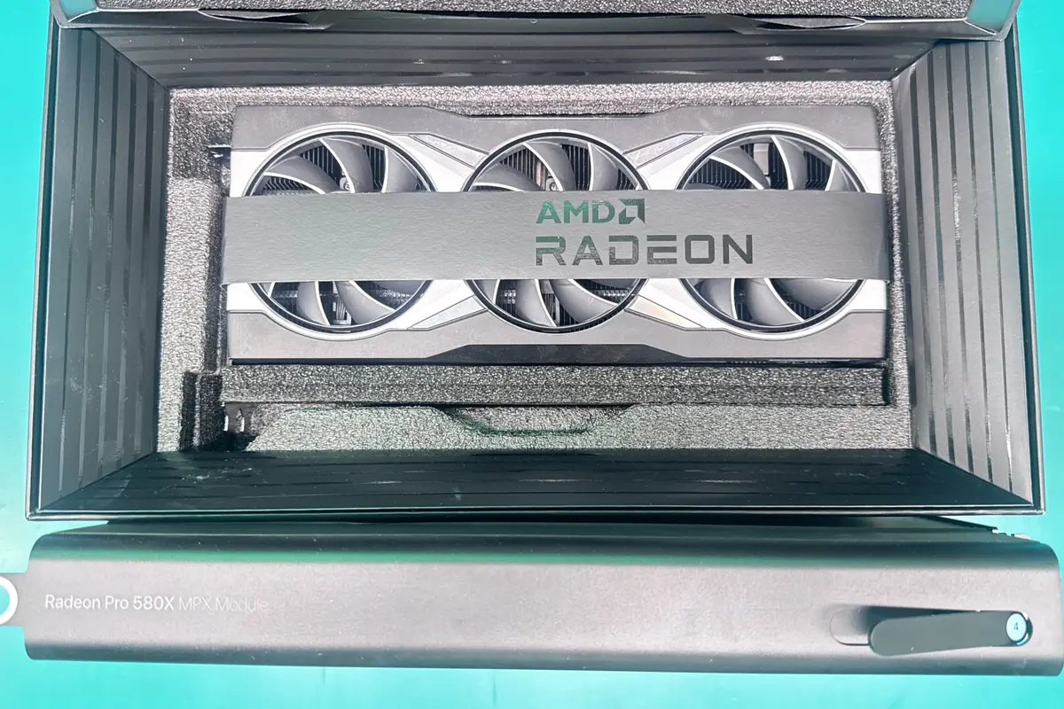 AMD Radeon Pro 580X MPX Module graphics card in packaging on green workbench at WarriorMac Tampa