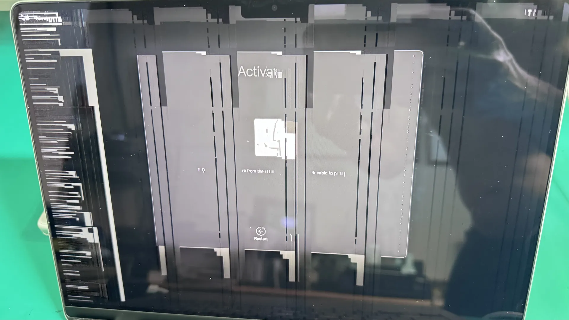 MacBook with cracked screen on WarriorMac repair workbench