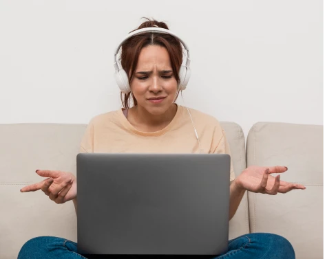 Frustrated woman with MacBook that won't turn on