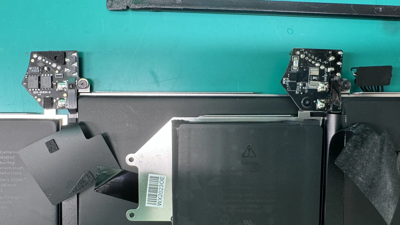 Close comparison of a genuine Apple 820-01654-A battery controller and a fake non-OEM controller board