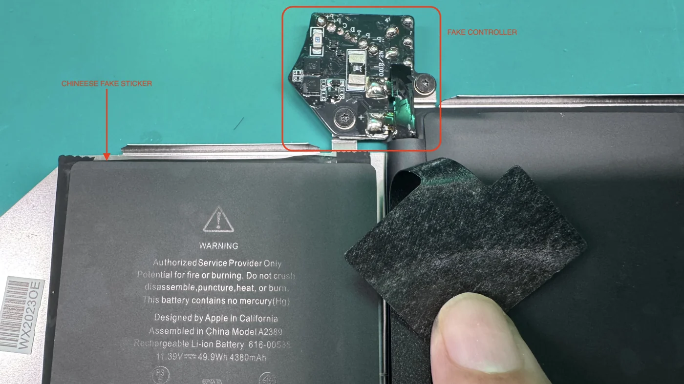 Counterfeit MacBook battery with fake controller board and fake Chinese warning sticker